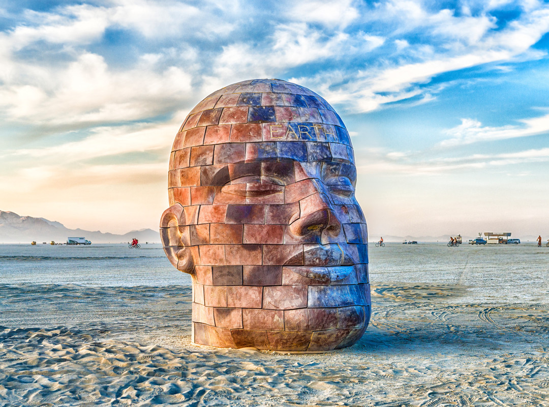 Colossal ceramic brick human head reminiscent of the temple carvings of Angkor Wat or the great Olmec heads of Central America, a contemporary relic of a civilization not yet past. Site specific sound and light elements will be incorporated into the artwork.